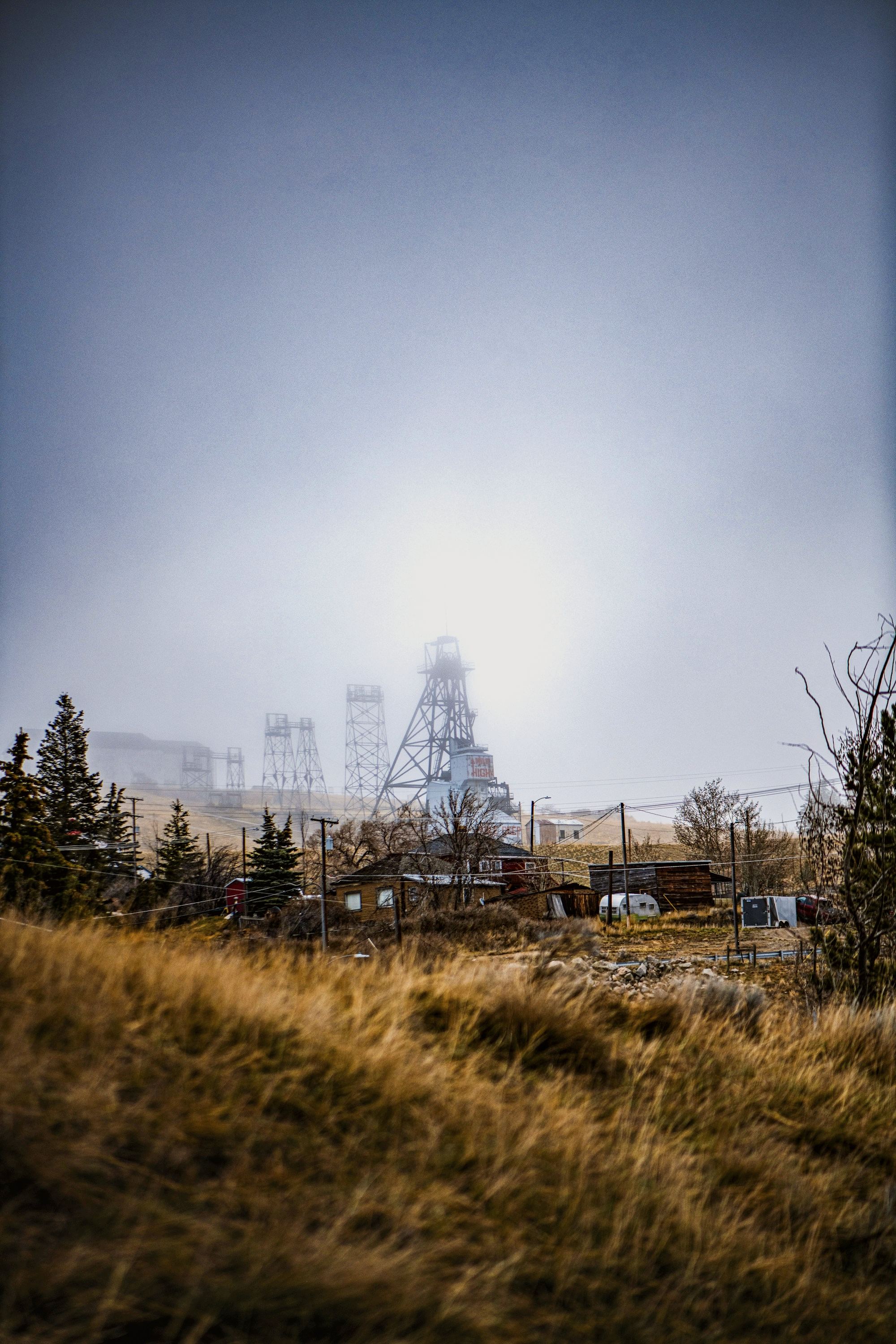 Headframes over a mine under a hazy sky