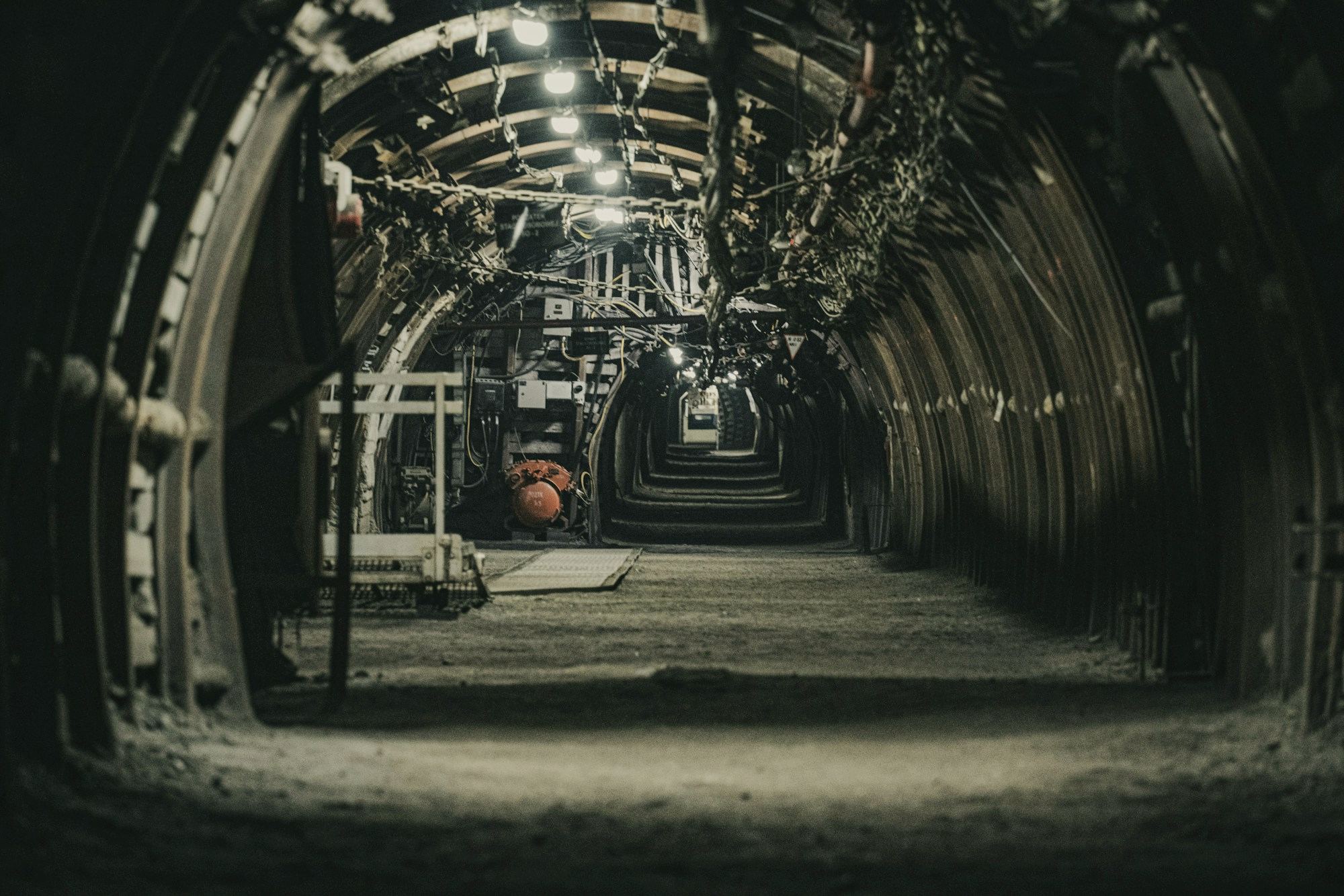 A tunnel lined with machinery and services